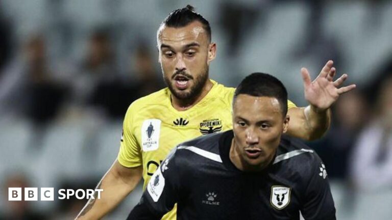 Clayton Lewis of the Wellington Phoenix challenges Kearyn Baccus of Macarthur FC during an Australia Cup quarter-final in August 2022