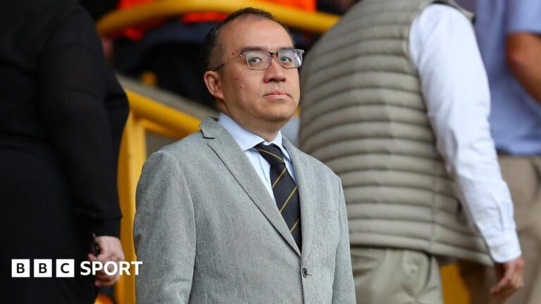 Wolves: Jeff Shi leaves Premier League basement side as he steps down Jeff Shi at Molineux in a grey suit, a shirt and tie and dark-rimmed glasses, looking in the direction of the camera