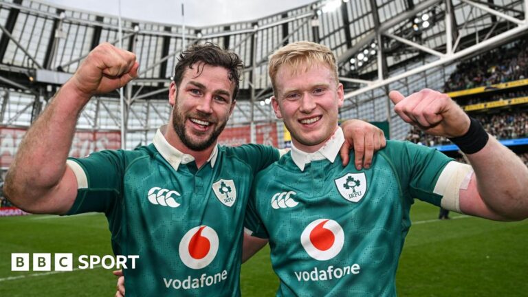 Six Nations 2026: Seconds from title but Triple Crown winners Ireland on right track Caelan Doris and Jamie Osborne in a celebratory pose, arm in arm, with each man raising a clenched fist and smiling, while wearing Ireland's green shirt