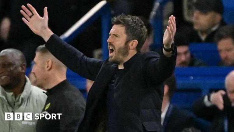 Man Utd manager Michael Carrick holds his arms out