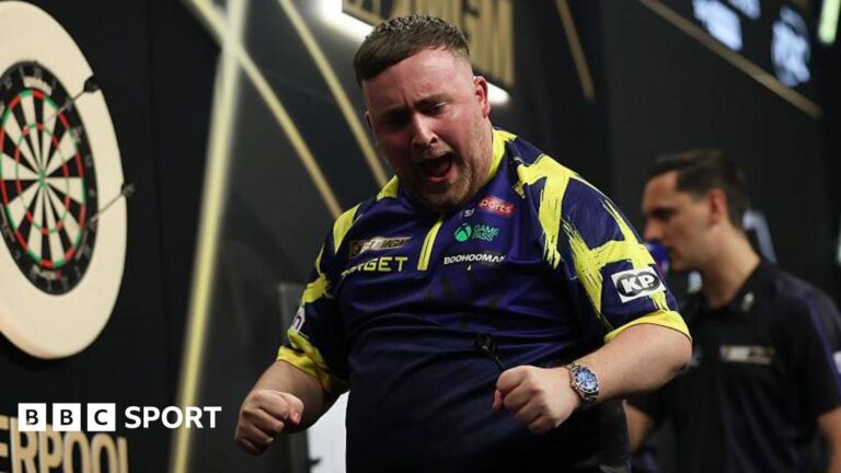 Luke Littler celebrating on the stage