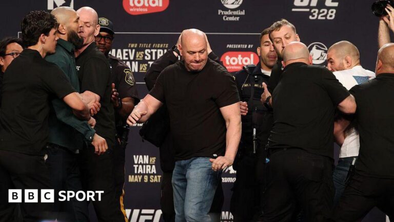 Sean Strickland and Khamzat Chimaev are held back by security at a UFC 328 news conference
