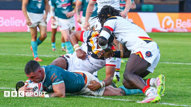 Curtis Sironen (left) has the ball down on the tryline for St Helens with two Bradford defenders on top of him