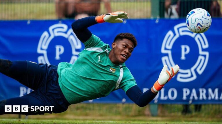 Zion Suzuki dives to make a save while warming up for Parma